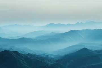 Obraz premium Misty mountain range layered in shades of light blue