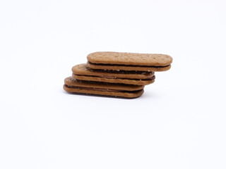 Stack of chocolate cream sandwich biscuits on a white background, sweet and crunchy with visible sugar crystals