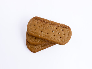 Stack of chocolate cream sandwich biscuits on a white background, sweet and crunchy with visible sugar crystals