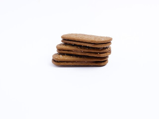 Stack of chocolate cream sandwich biscuits on a white background, sweet and crunchy with visible sugar crystals