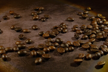 Roasted coffee beans on the dark table background