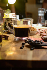 a cup of brewed coffe and garnish on the table