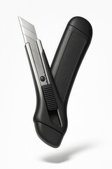 Obraz premium Black utility knife with a retractable stainless steel blade and textured grip handle on transparent background.