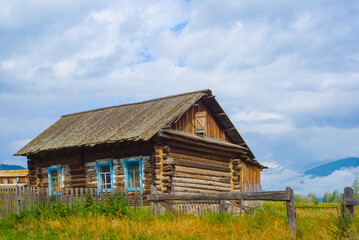 alone wooden village house among fields