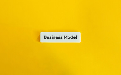 Business Model Text onLetter Tile on Yellow Background. Minimalist Concept for Strategy, Innovation & Startups.