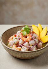 Close up shot of a beautifully plated ceviche with shrimp and mango.