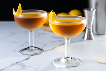 Paper plane cocktail on white marble and black background