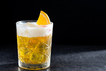 Classic cocktail whiskey sour on black background. Copy space