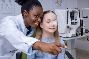 Girl having an exam at the ophthalmologist office and looking positive