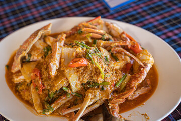 Stir-fried crab curry, soft shell crab yellow curry with sweet pepper and vegetables.  in a restaurant by the sea, Phuket