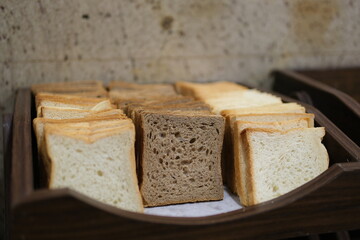 sliced white bread and buns in wicker baskets. Perfect for projects related to baking, breakfast, or food service. Warm tones and inviting texture.