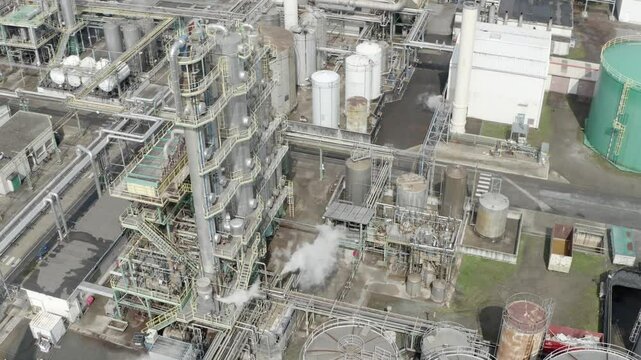 Aerial circling industrial processing unit with steam, tanks, pipes, Veille-Saint-Girons, France. Chemical plant operation