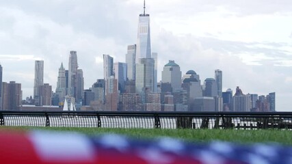 New York City waterfront skyline, Manhattan Downtown World Trade Center skyscraper. Cityscape from New Jersey, United States. American flag 11 September, USA. Independence and Remembrance symbol. Wind