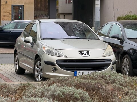 Silver Peugeot 207 French car parked on street