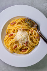 close up of spaghetti carbonara in white bowl