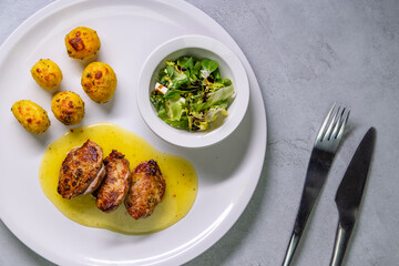 roasted chicken breast with sauce and roasted potatoes