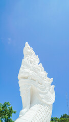 Phuket Big Buddha statue. afternoon light sky and blue ocean are on the back of white Phuket big Buddha is the one of landmarks on Phuket island Thailand.