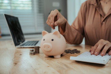 Close-up of woman putting coins into piggy bank, symbol of savings, financial growth, investment, future security, budgeting and basic money management education.