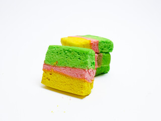 Colorful layered cookies in green, pink, and yellow on a white background. Bright and playful baked dessert,