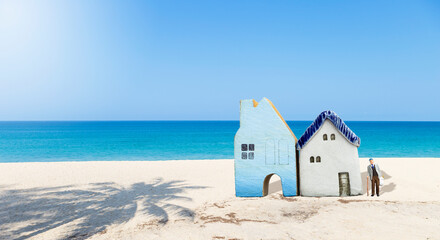 Miniature old man with house model on tropical beach, retirement home, nursing home