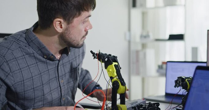 Team of male developers work code control robotics system and software automation project write prompt AI data bot at office. Artificial intelligence, collaboration, robotic, debugging, machine learn.