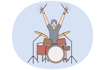 Man drummer member of youth rock band raise hands up starting concert