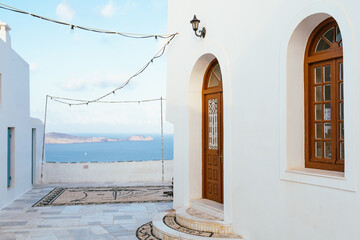 Traditional Mediterranean building with arched door and windows, overlooking the sea