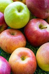 Apples of different varieties such as Granny Smith, Starking, Fuji are on the table