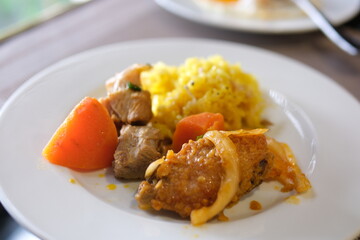 Plate, food, vegetables rice meat carrots Asian traditional culinary dish pilaf holding kitchen spoon. Ingredients rice, meat, vegetables carrot, spices and fat. National Eastern tasty food.