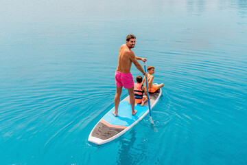 Photo from Hurghada in Egypt Father with sons on paddleboard