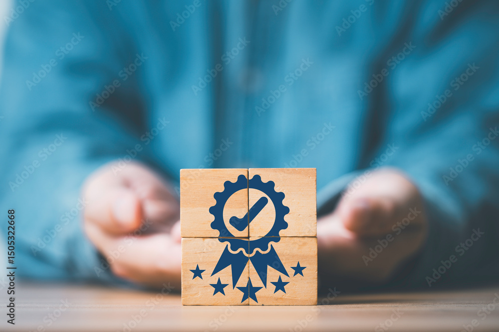 Aufkleber businessman hand giving and showing the best quality assurance which print screen on wooden block cu