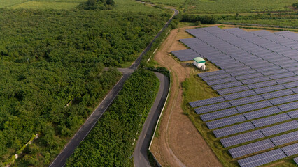 An aerial view of a solar power plant, also known as a solar park, is a large-scale photovoltaic (PV) system designed to supply commercial electricity to the grid.