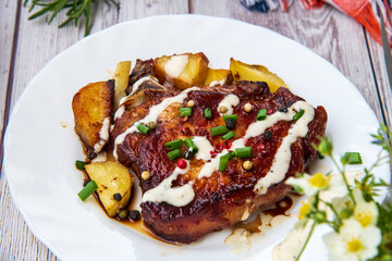 Grilled bone in pork chops with potato,