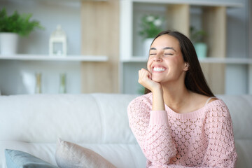 Happy woman sitting at home relaxing