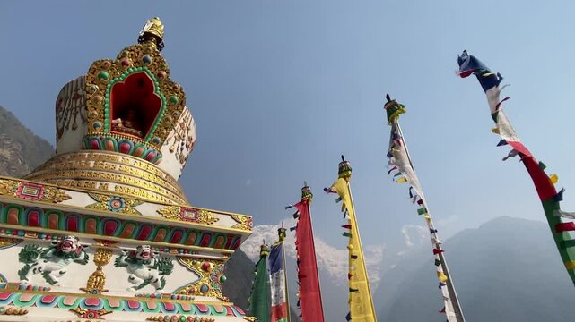 Chhomrong Gumba Stupa decorated with colorful prayer flags in Annapurna Base Camp trek, Nepal.	
