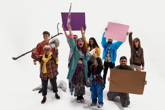 Group of protesters raising hands and signs, showing resistance with cardboard and megaphones against white background. Concept of social protest, housing struggle, crisis response, human rights - Powered by Adobe