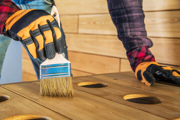 Crafting Wooden Surfaces With a Brush in a Workshop During Daytime Activities