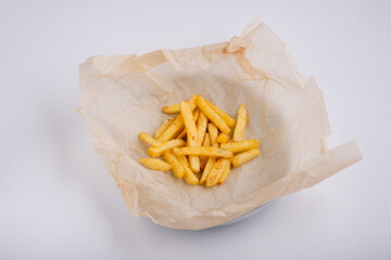 Fast food: French fries on a plate on a white background. Serving for a bar, restaurant.
