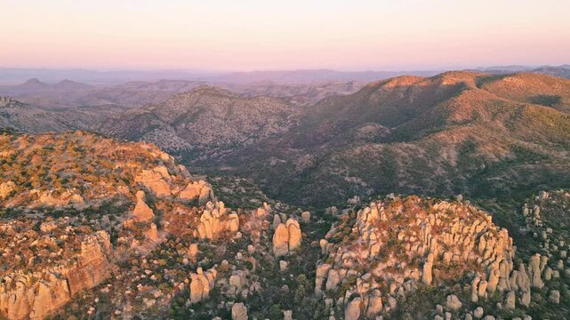 Golden hour light over rocky formations in Valle de los Monjes, Creel, Mexico