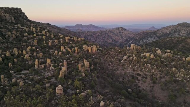 Rock formations in Chihuahua's Valle de los Monjes at dusk, peaceful and wide view
