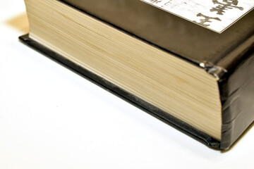 A hardcover reading book lies on the table.