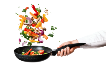 Fresh vegetables tossed into a pan for cooking healthy meal preparation
