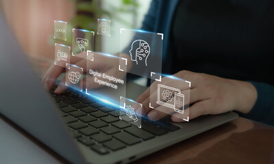Digital Employee Experience concept.Hands typing on a laptop keyboard with futuristic digital interface such as digital employee experience,  digital tools, technologies and platforms in organization.