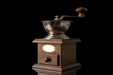 One manual coffee grinder, close-up, isolated onblack background.
