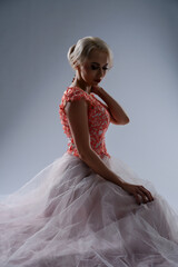 Bride in blood-stained gown poses dramatically in a studio setting