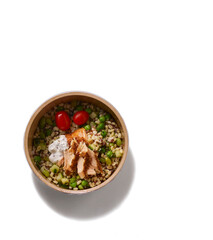 Healthy grain bowl with grilled chicken tomatoes and creamy dressing isolated