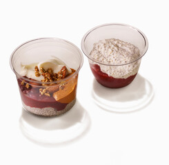 Chia seed pudding parfaits healthy dessert in plastic cups on white background