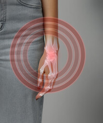 Hand and wrist anatomy illustration with highlighted joint and bone structure for educational...