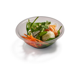 Fresh salmon salad in a bowl with carrots spinach and bean sprouts