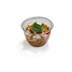 Fresh chicken chickpea salad with spinach in a clear plastic bowl